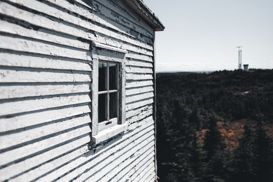 Weathered wooden house with peeling paint
