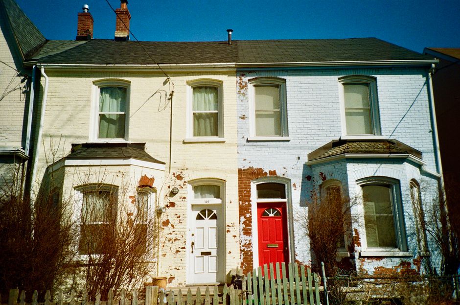 Row of houses with painted red and white doors