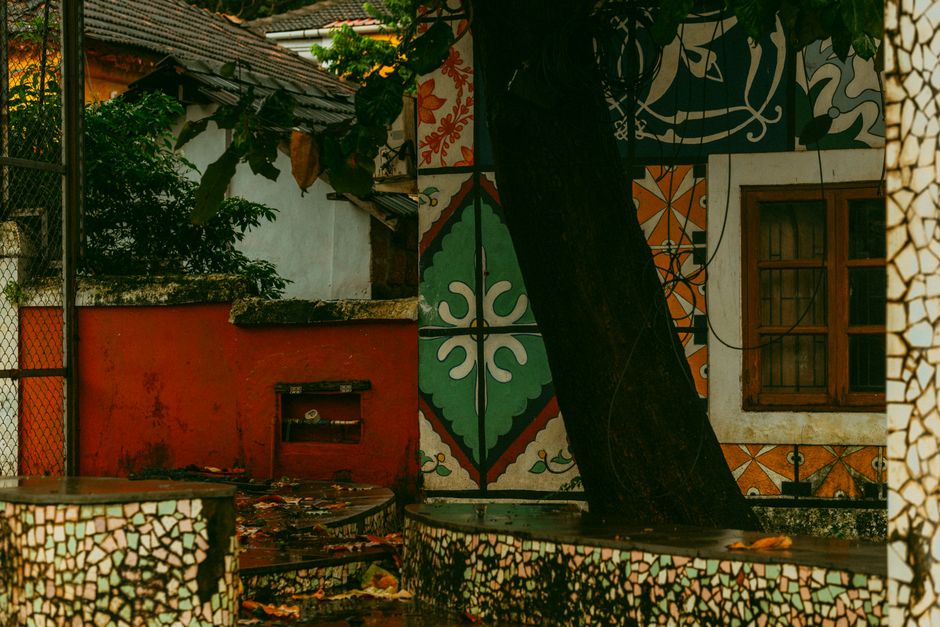 Painted wall with colourful patterns and a tree in front